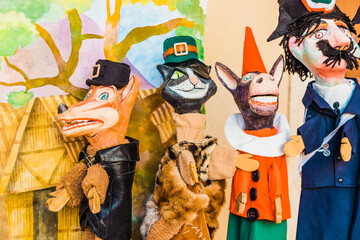 Colorful handmade Italian-style puppets in a children's theater performance.
