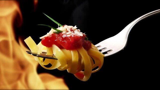 Pasta on fork with tomato sauce