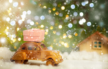Retro car is carrying a Christmas gift. Online store and delivery concept