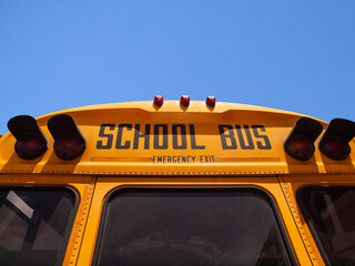 School bus sign above rear door emergency exit.