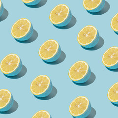 Summer pattern made with blue lemon slice on pastel blue background. Minimal style. Foof concept.