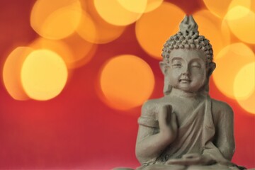Buddha on red background with golden bokeh .Meditation and relaxation symbol.Buddhism religion background.