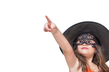 Child in masquerade mask and hat shows finger in copy space isolated