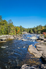 Fototapeta na wymiar Penobscot River surrounded by early fall foliage in Baxter State Park Maine