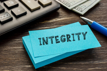 Business concept about INTEGRITY with inscription on the piece of paper.