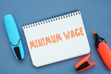  Financial concept about MINIMUM WAGE with sign on the sheet.