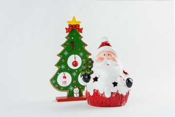 Christmas tree and Santa Claus with decorations on white background. Christmas ornament. Selective focus.