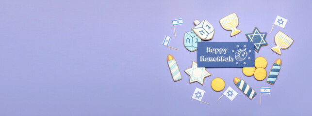 Obraz premium Tasty cookies and greeting card for Hanukkah on color background with space for text