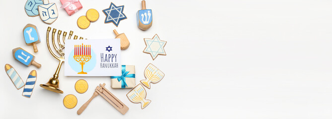 Different symbols of Hanukkah and greeting card on white background with space for text
