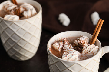Cups of hot coffee with marshmallows on dark background, closeup