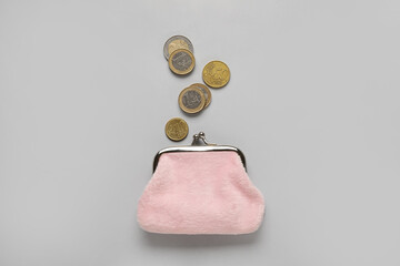 Pink wallet with coins on grey background