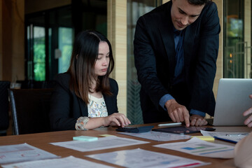 Business team discussing the charts and graphs showing the results at meeting accounting and financial