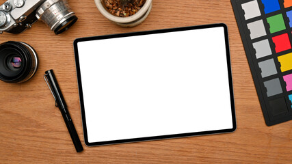 Professional photo editor office desk with tablet mockup on wooden background