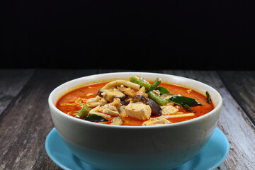 Traditional spicy red curry soup of tofu sheet mixed with chilly and string bean serving in the bowl. Famous vegetarian menu in Asia restaurant. 