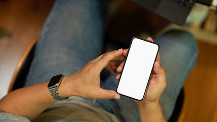 ?ale holding mobile phone, texting, blank screen mockup