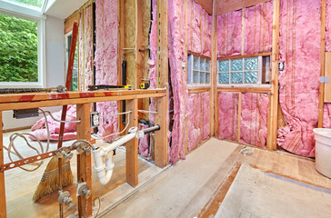 Pipes and wiring from the old counter await relocation to the wall behind them after old kitchen is...