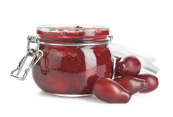 Jar of tasty dogwood jam and berries on white background