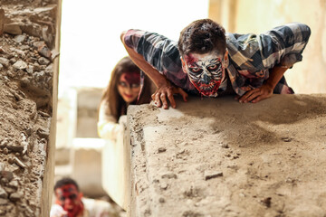 Scary zombies in ruined building