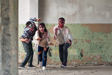 Scary zombies in ruined building