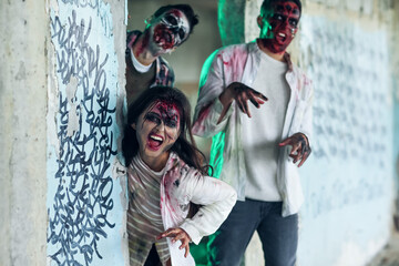 Fototapeta na wymiar Scary zombies in ruined building