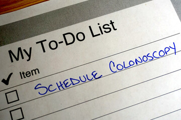 Handwritten reminder on a to do list to schedule a colonoscopy