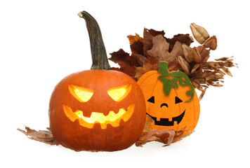 Carved pumpkin with Halloween decor on white background