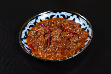 Asian food. Beef in spicy sauce with sesame seeds and chili pepper