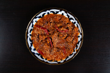 Asian food. Beef in spicy sauce with sesame seeds and chili pepper