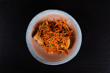 Grated carrot salad with chicken, chopped garlic chives and salad oil