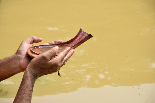 TARPAN - A Hindu ritual, the sacrament of offering drinking water to the manes. This is well practised on Mahalaya day by hindu devotees on the banks of the holy river Ganga.