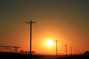 Fototapeta na wymiar power lines at sunset north of Hutchinson Kansas USA.