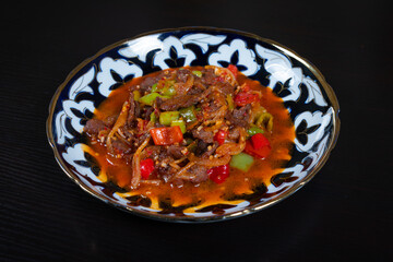 Asian food. Roasted beef with bell pepper and spices on plate