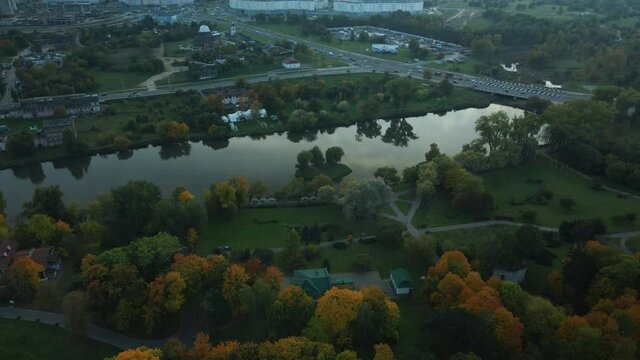 Flight over the autumn park. Trees with yellow autumn leaves are visible. The park pond is visible. Aerial photography.