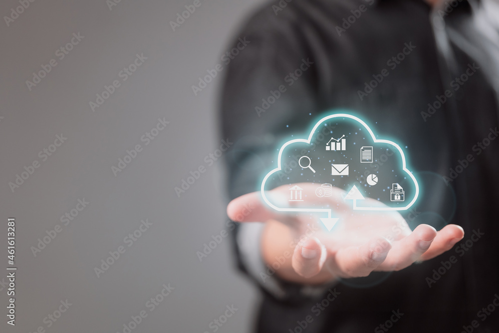 Poster A businessman holds a virtual cloud computing device to transfer data information and upload and download applications. The concept of technological transformation.