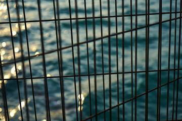 Metal fence of the sea promenade.