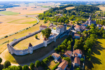 Scenic aerial view of small township of Villebois-Lavalette in southwestern France overlooking ancient castle and parish church in summer