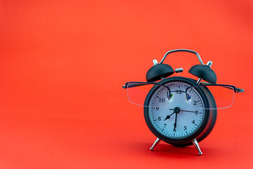 Concept Education or business Alarm clock and teacher glasses Business objects isolated on colorful background Back to school concept