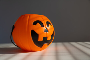 A basket for sweets in the shape of a pumpkin jack on a lantern on a white background.