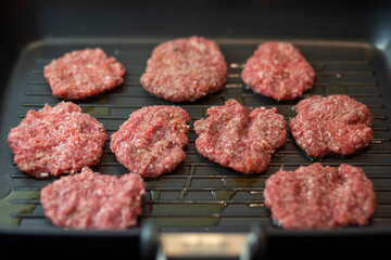 Frying four round beef meat for hamburger