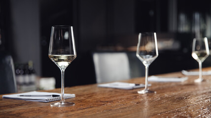 Banner Concept tasting white wine, row glasses with alcohol and notepad on table