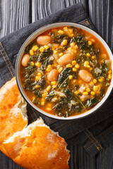 Kara lahana corbası Tarifi Turkish soup with kale close-up in a bowl on the table. Vertical top view from above