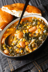 Kara lahana corbası Tarifi Turkish soup with kale close-up in a bowl on the table. vertical