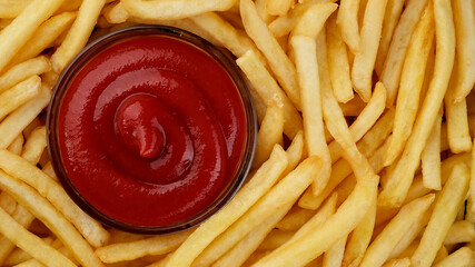 French fries and ketchup sauce top view. Fry potatoes