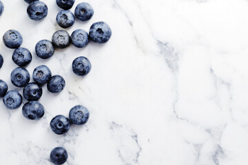 composition of ripe blueberries on a textured marble background