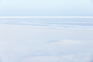 Fototapeta na wymiar Empty winter landscape. White snow on frozen Baltic Sea