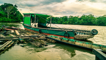Fototapeta na wymiar Traditional wooden boat as main transportation in upper Mahakam. Wooden boat docked in Mahakam river