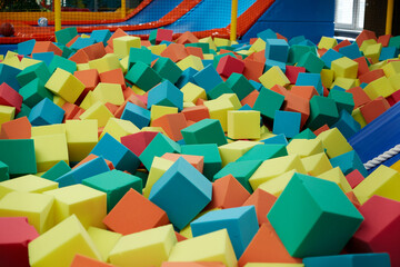 Colored soft cubes fill the dry pool for children's jumping