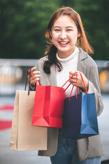 shopping, buying, lifestyle concepts young women with colorful shopping bags and shopping