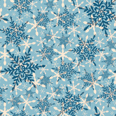 Winter seamless pattern of hexagonal snowflakes on a blue background. 