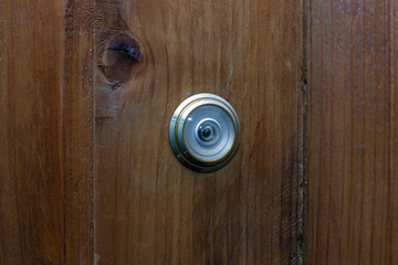 Fototapeta premium peephole on a wooden door, close-up